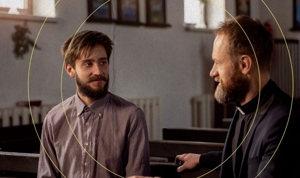 priest talking to man